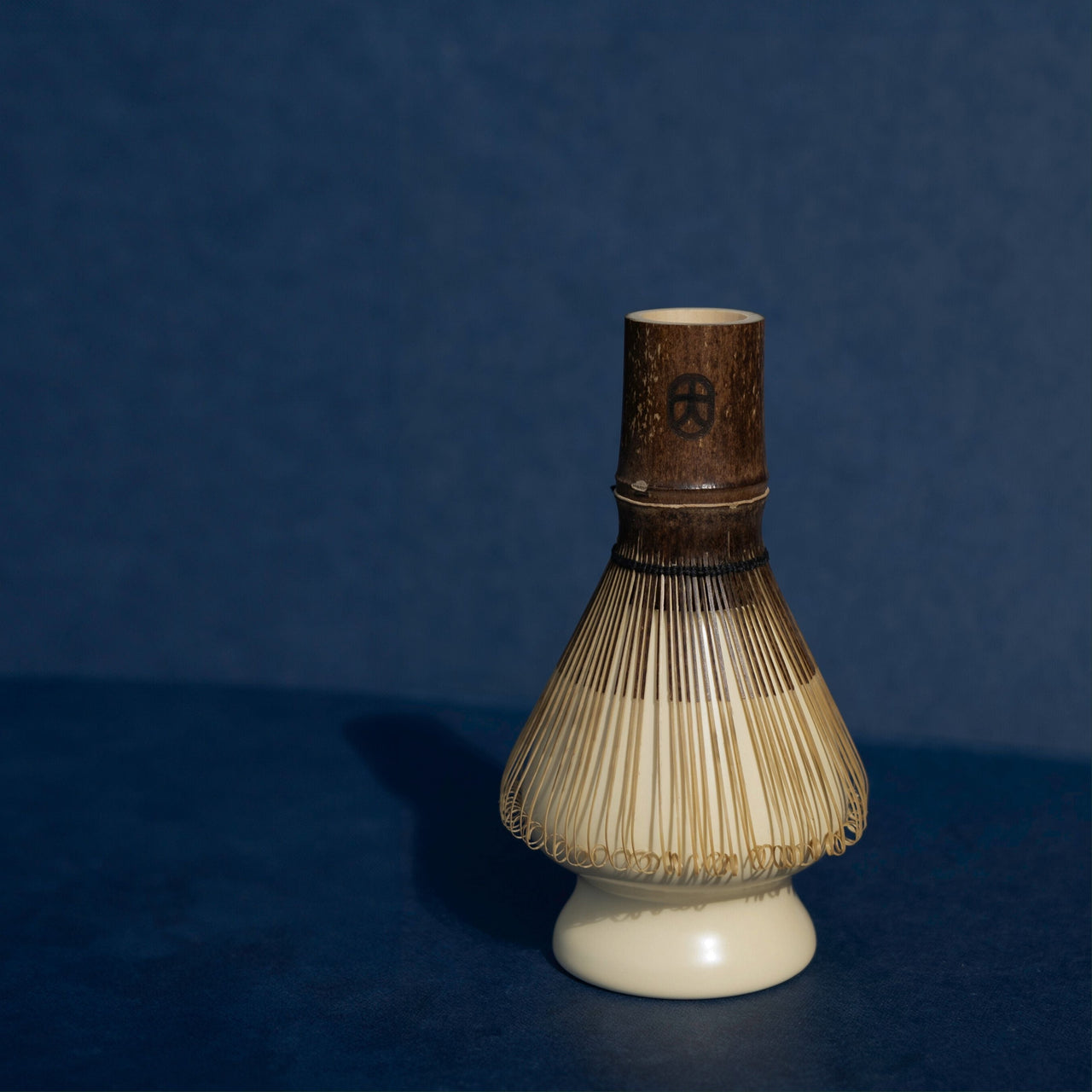 Traditional Japanese whisk on a blue background