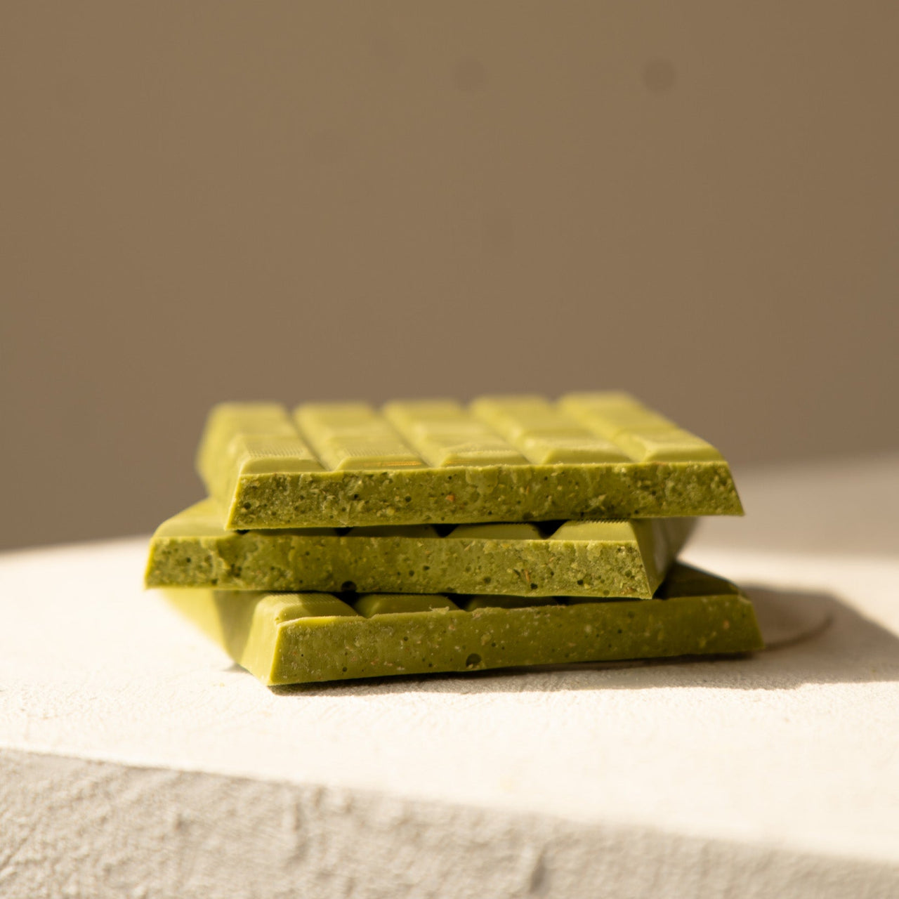 Pink chocolate bar with 'YOISHO' branding on a beige background